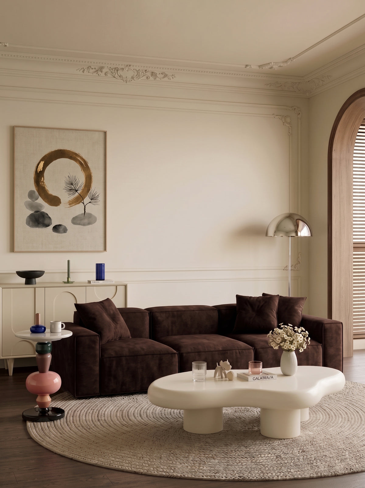 Elegant living room with dark sofa, sculptural coffee table and cream sideboard