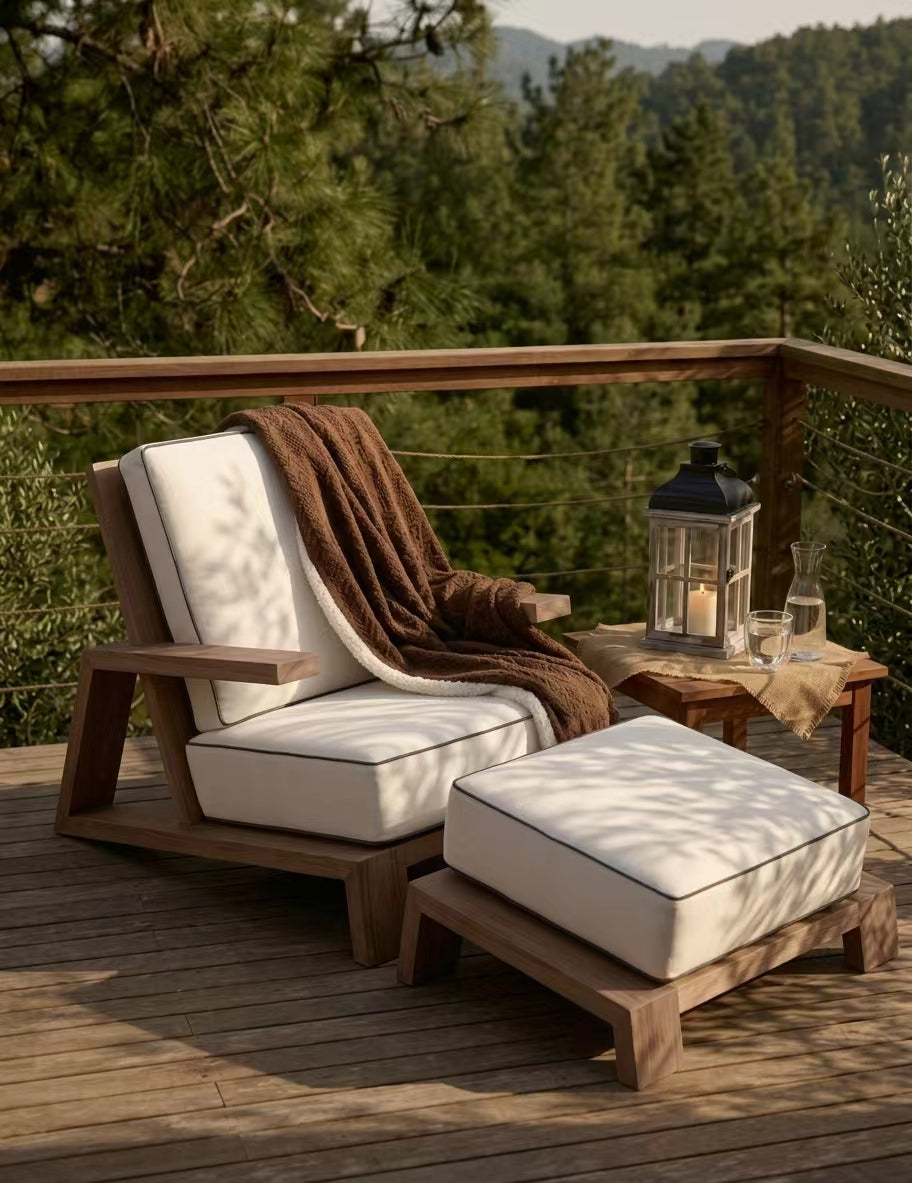 Outdoor wooden lounge chair and ottoman with blanket and glassware