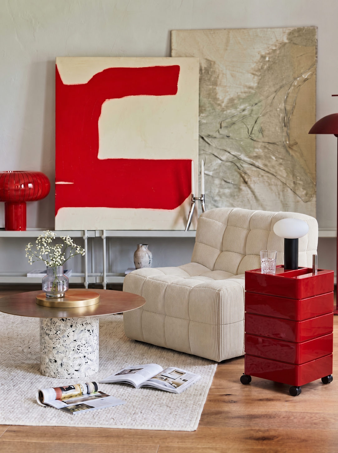 Red accent living room with white armchair, side table and coffee table